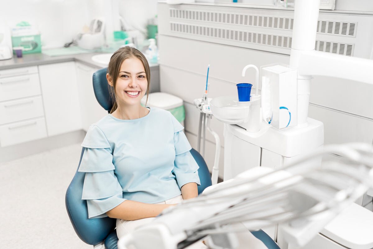 A Beautiful Lady Seating On Dental Chair Is Excited For Her Dental Treatment