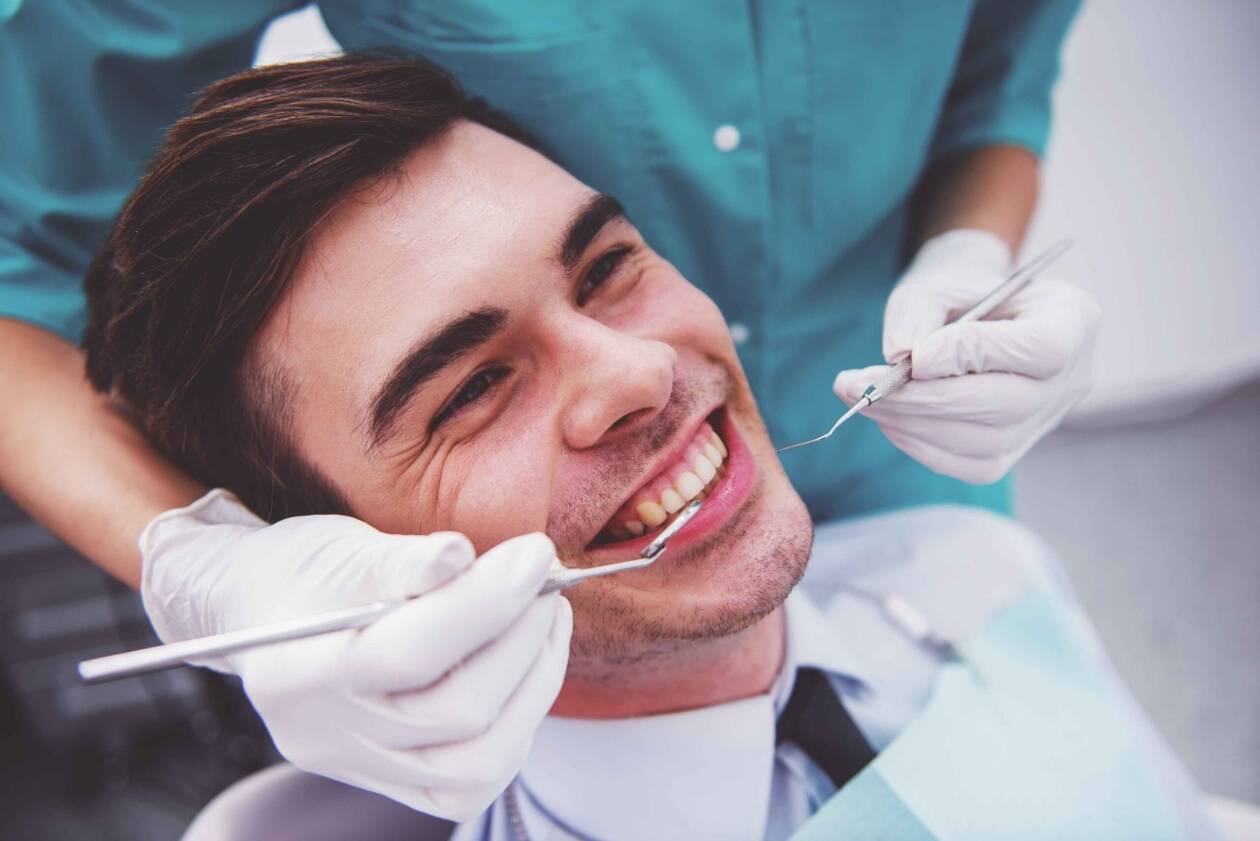 Smiling patient at a dental examination.