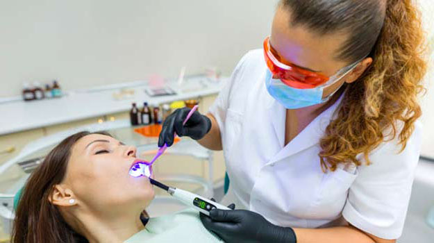 Adult Female Dentist Treating Patient Woman Teeth