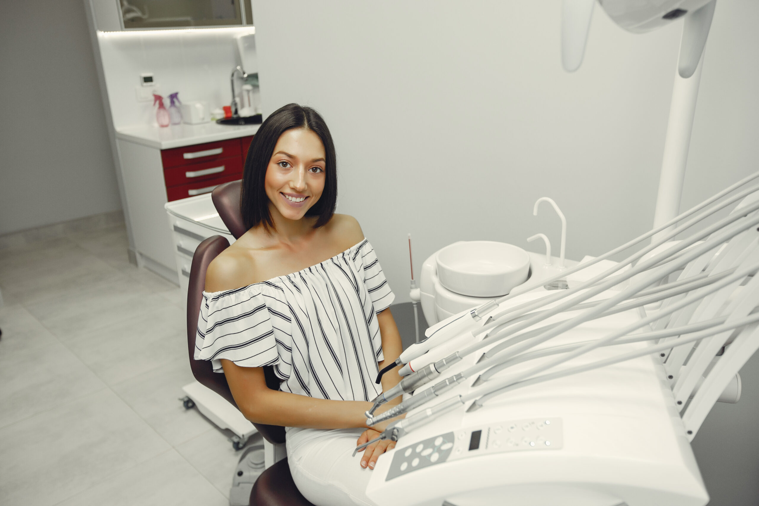A young woman visited a dentist. Lady sitting near dentist instruments